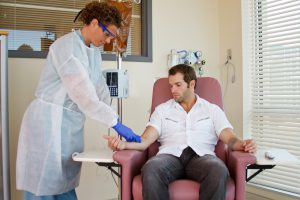 Nurse attaching intravenous for patient chemotherapy